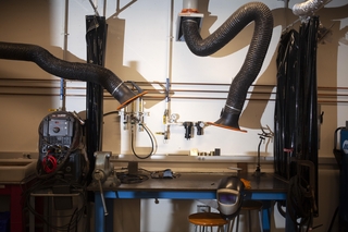 a series of large tubes over a desk.